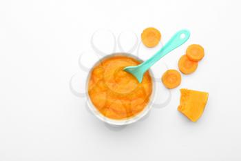 Bowl with healthy vegetable puree for baby on white background, top view�