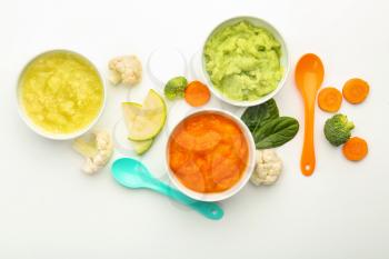 Flat lay composition with healthy baby food on white background�
