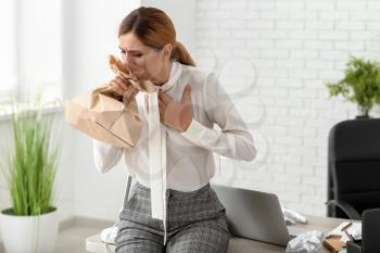 Woman having panic attack at workplace�