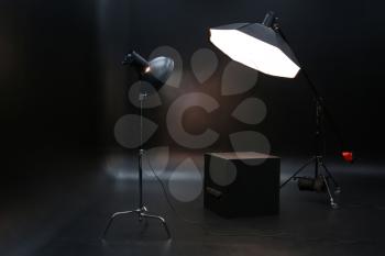 Professional lighting equipment on dark background�