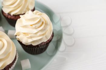 Tasty chocolate cupcakes on white table�