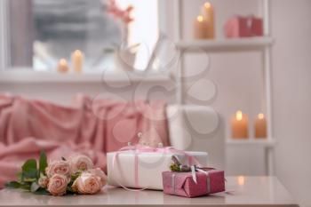 Beautiful gift boxes with flowers on light table�