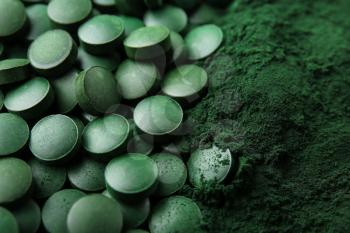 Spirulina tablets with powder, closeup�