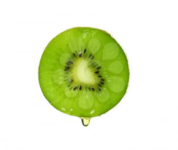 Essential oil dripping from kiwi slice on white background�