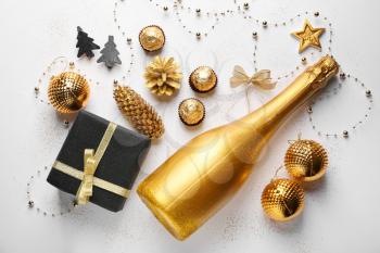 Beautiful composition with champagne and Christmas decor on white background�