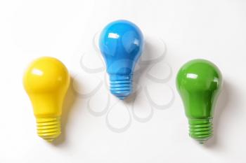 Colorful light bulbs on white background�