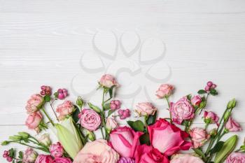 Beautiful pink flowers on white wooden background�
