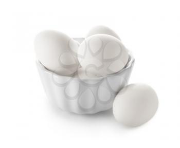 Bowl with raw chicken eggs on white background�