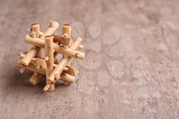 Wooden puzzle on textured background�