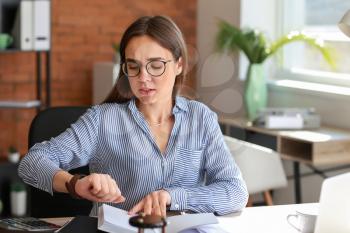 Stressed businesswoman trying to meet deadline in office�