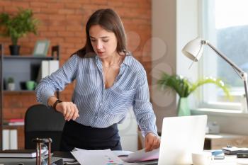 Stressed businesswoman trying to meet deadline in office�