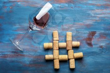 Hashtag sign made of wine corks on color wooden background�