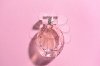 Bottle of perfume on color background�