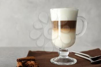 Glass cup of tasty aromatic latte on table�