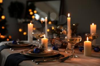 Burning candles on beautiful  table setting for Christmas dinner�