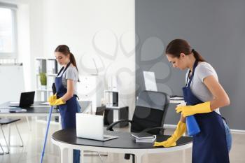 Team of janitors cleaning office�