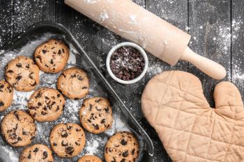 Tasty cookies with chocolate chips on wooden table�