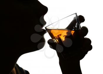 Silhouette of woman drinking whiskey on white background. Concept of alcoholism�