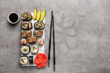 Composition with tasty sushi on grey background�