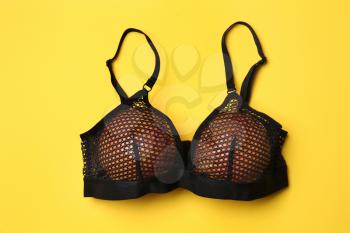 Ripe grapefruits in bra on color background�