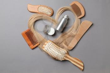 Flat lay composition with cosmetics for hair on grey background�