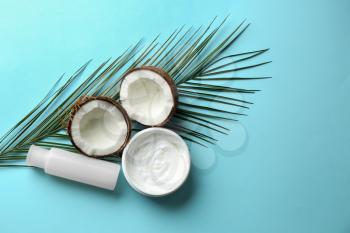 Flat lay composition with coconut and natural cosmetics for hair on color background�