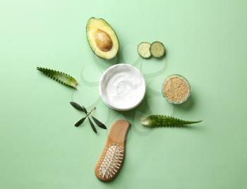 Flat lay composition with avocado and natural cosmetics for hair on color background�