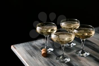 Glasses of champagne on wooden table�