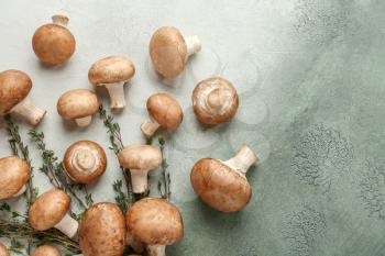 Fresh mushrooms with thyme on color table�
