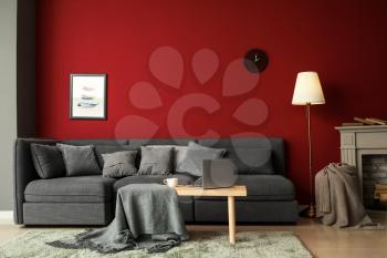 Stylish interior of room with comfortable big sofa�