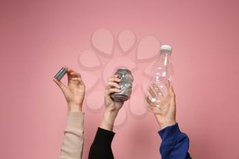 Many hands with different types of garbage on color background. Ecology concept�