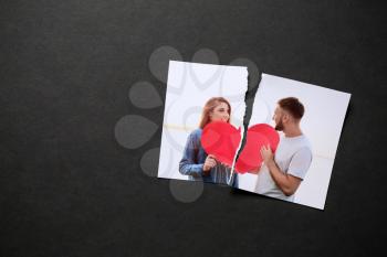 Torn photo of happy couple on dark background. Concept of divorce�