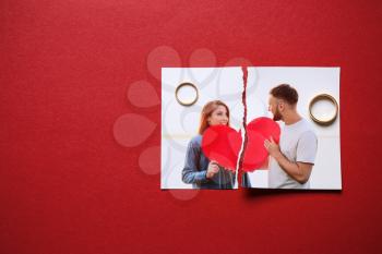 Torn photo of happy couple with rings on color background. Concept of divorce�