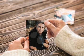 Woman holding torn part of photo with her ex-husband. Concept of divorce�