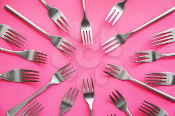 Set of forks on color background�