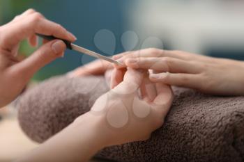 Young woman getting beautiful manicure in salon�