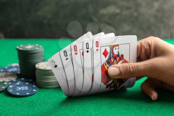 Young woman playing poker in casino, closeup�