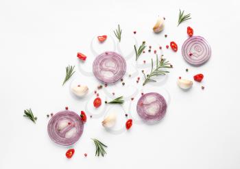 Cut onion and spices on white background, flat lay�