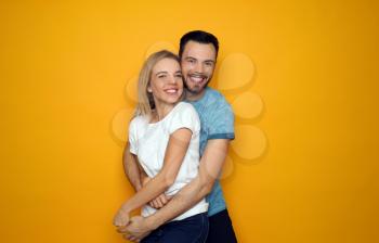 Stylish young couple on color background�