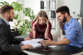 Young emotional couple visiting divorce lawyer in office�