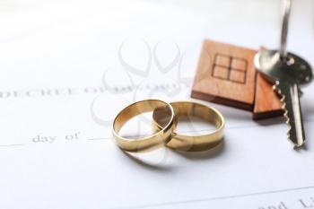Rings with key from house and decree of divorce, closeup�
