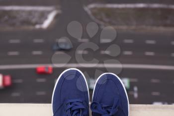Male shoes on the edge of roof. Concept of suicide�