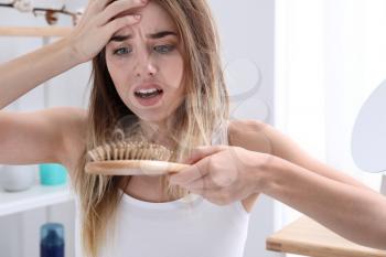 Woman with hair loss problem at home�