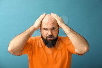 Man with hair loss problem on color background�