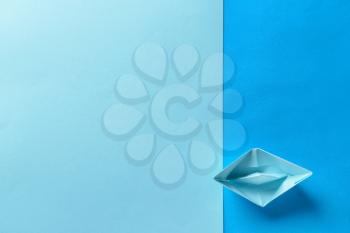 Origami boat on color background�