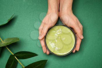 Female hands with matcha tea on color background�