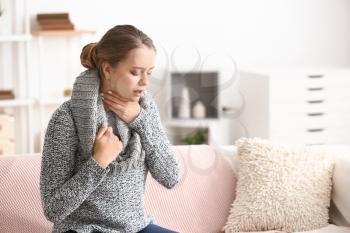 Young woman having asthma attack at home�