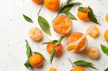 Jars of tasty tangerine jam on light table�