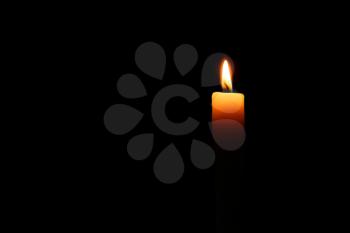Burning candle in darkness�