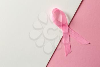Pink ribbon on color background. Breast cancer awareness concept�